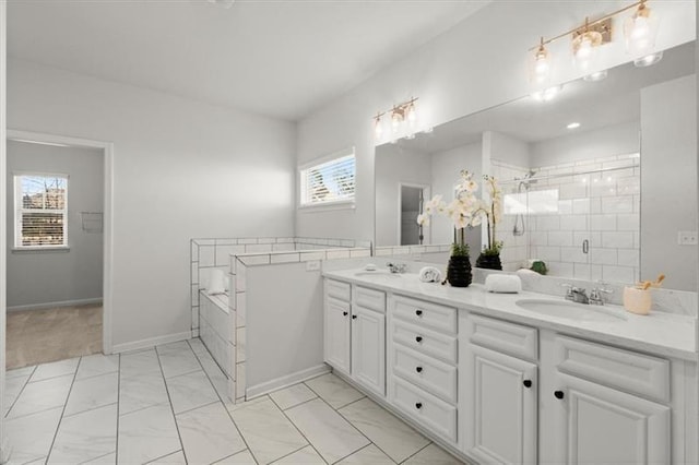 full bathroom featuring double vanity, marble finish floor, tiled shower, a bath, and a sink