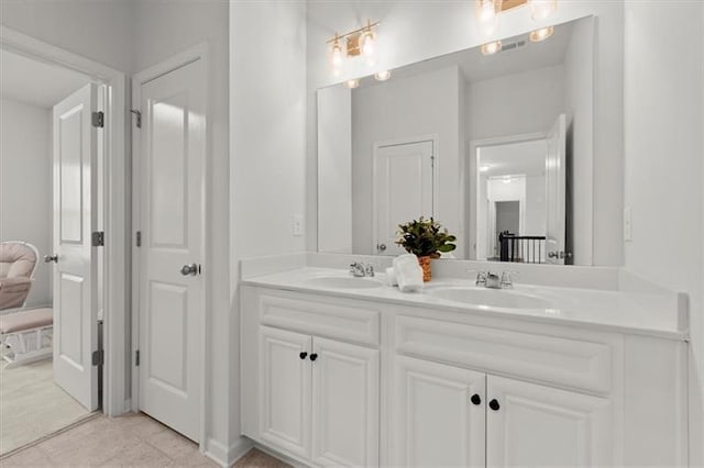 full bath featuring a sink, tile patterned floors, and double vanity