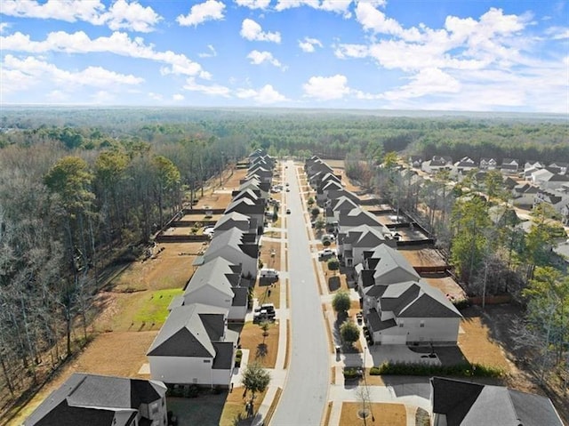 aerial view featuring a view of trees and a residential view