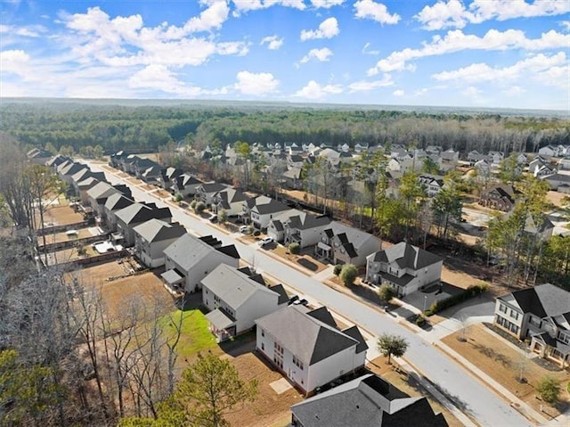 birds eye view of property featuring a view of trees and a residential view