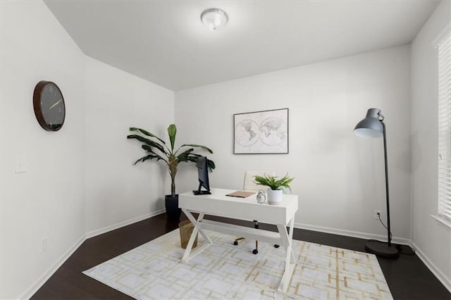 home office featuring baseboards and wood finished floors