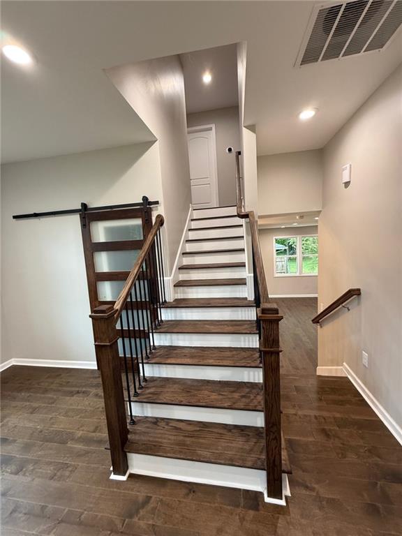 hallway with carpet floors and baseboards
