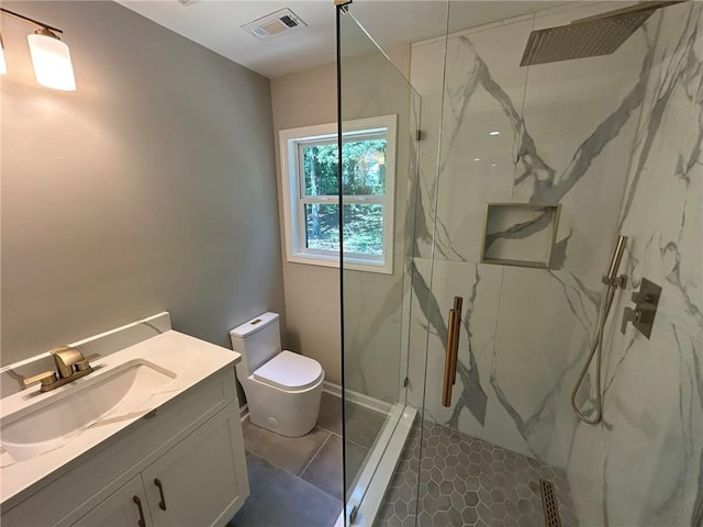 full bathroom featuring toilet, a marble finish shower, vanity, and baseboards