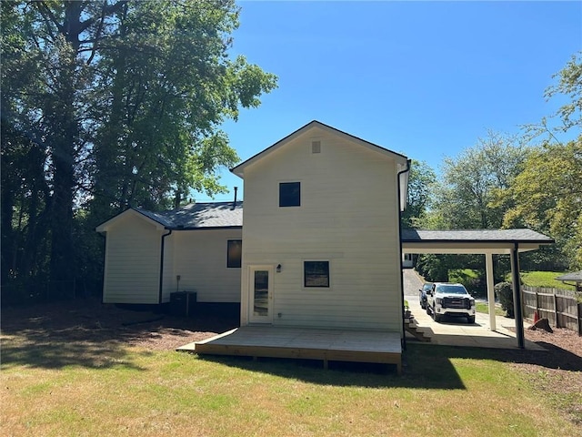 back of property featuring a carport