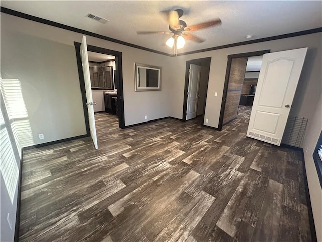 unfurnished bedroom with dark wood finished floors, baseboards, visible vents, and ornamental molding