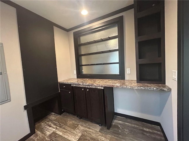 bathroom featuring built in shelves, baseboards, and wood finished floors