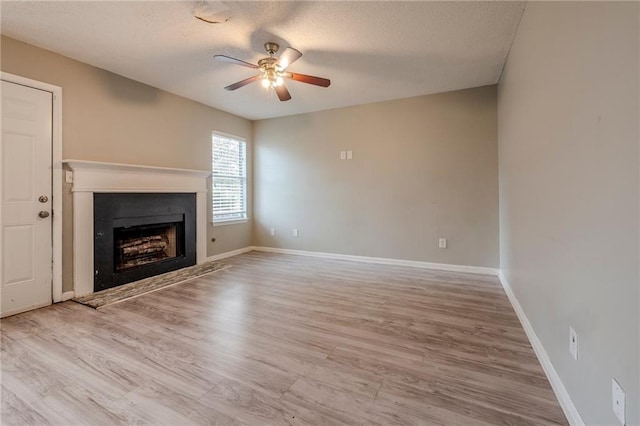 unfurnished living room with wood-type flooring, a textured ceiling, and ceiling fan