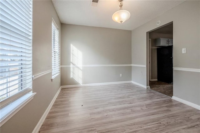 unfurnished room featuring light wood-type flooring