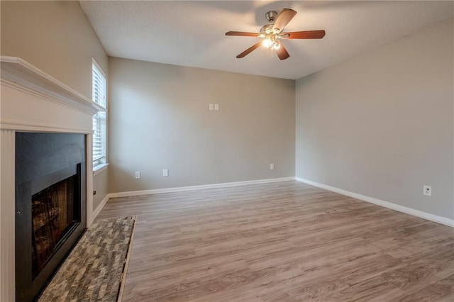 unfurnished living room featuring light hardwood / wood-style flooring and ceiling fan