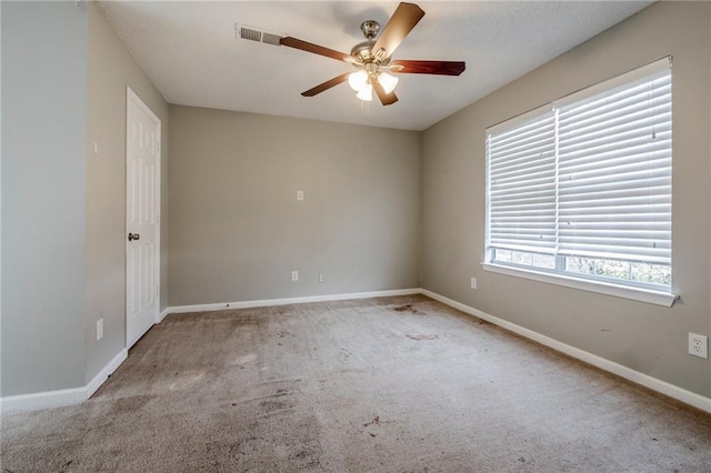 unfurnished room with ceiling fan and light colored carpet