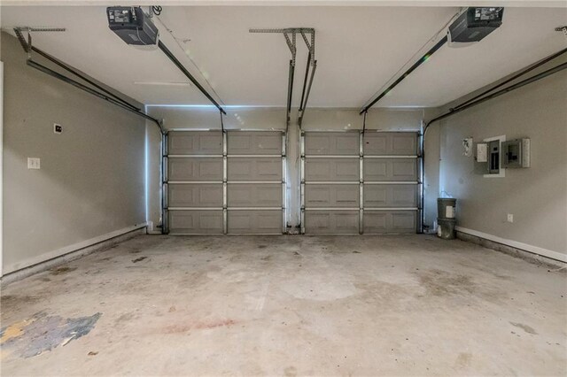 garage featuring electric panel and a garage door opener