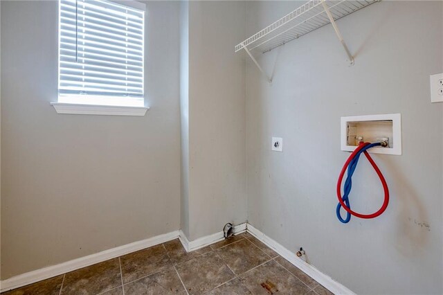 washroom with washer hookup, hookup for an electric dryer, gas dryer hookup, and dark tile patterned floors