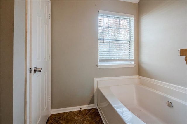 bathroom featuring tile patterned flooring and a bath