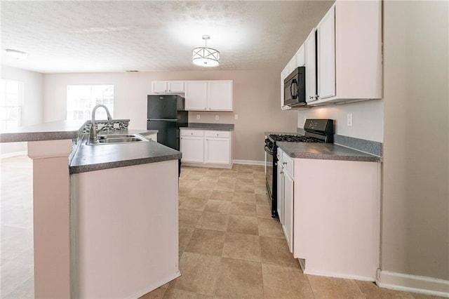 kitchen with a kitchen island with sink, a sink, white cabinetry, black appliances, and dark countertops