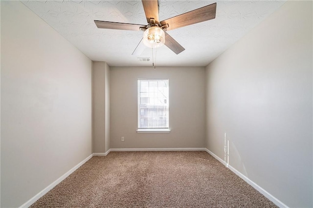 spare room with baseboards, visible vents, ceiling fan, a textured ceiling, and carpet flooring