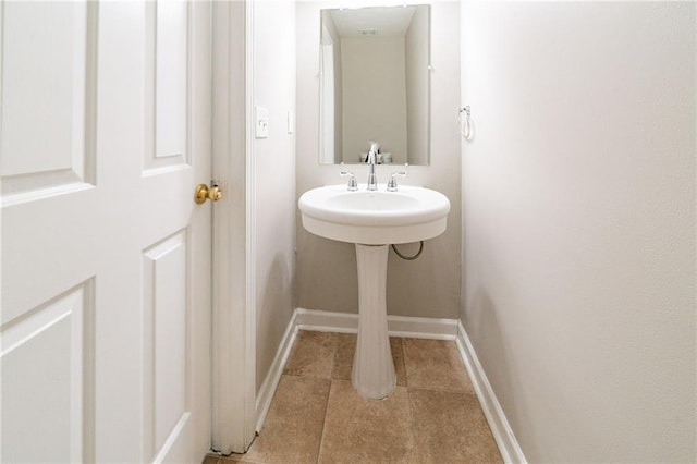 bathroom featuring baseboards and tile patterned floors