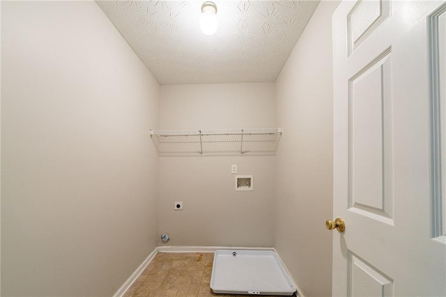 laundry area featuring a textured ceiling, hookup for an electric dryer, laundry area, washer hookup, and baseboards