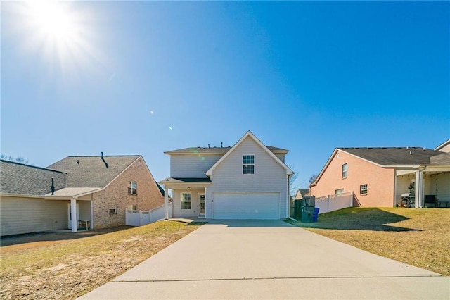 view of front of house with a garage, concrete driveway, fence, and a front lawn