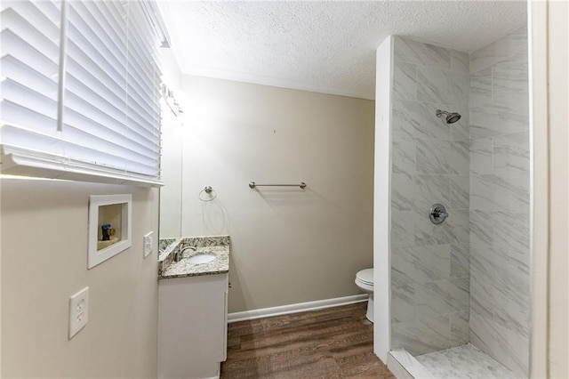 2363 Dabney Ter, Atlanta, GA 30344 - bathroom featuring a tile shower, vanity, a textured ceiling, and hardwood / wood-style flooring