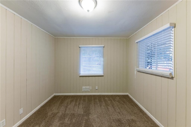 2363 Dabney Ter, Atlanta, GA 30344 - carpeted empty room featuring wood walls and crown molding