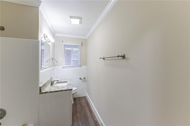 2363 Dabney Ter, Atlanta, GA 30344 - bathroom with ornamental molding, vanity, hardwood / wood-style flooring, tile walls, and toilet