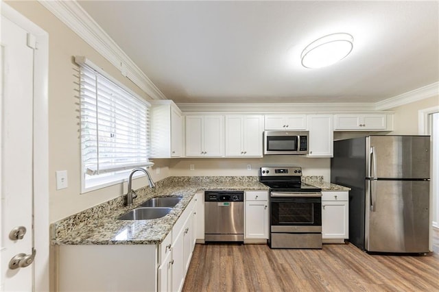 2363 Dabney Ter, Atlanta, GA 30344 - kitchen featuring sink, light hardwood / wood-style flooring, ornamental molding, appliances with stainless steel finishes, and white cabinetry