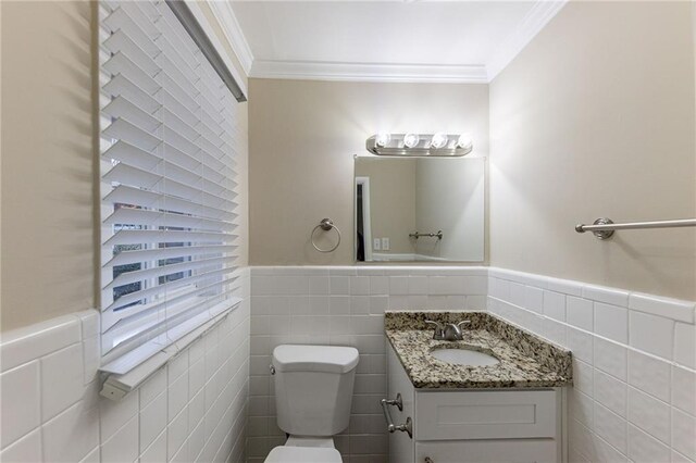 2363 Dabney Ter, Atlanta, GA 30344 - bathroom with crown molding, vanity, tile walls, and toilet