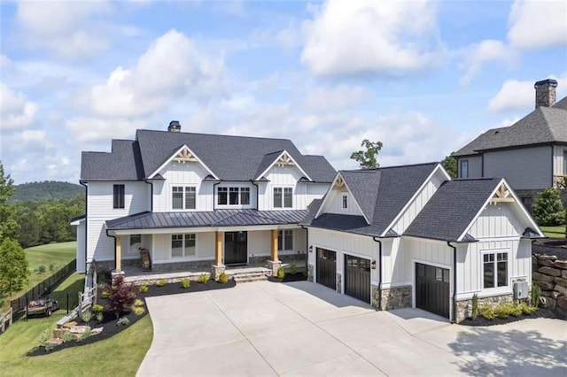 view of front of house featuring a garage, covered porch, and a front yard