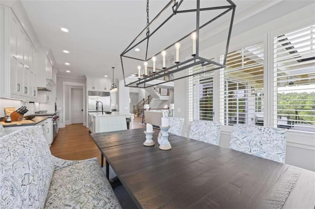 dining room featuring dark hardwood / wood-style flooring, a healthy amount of sunlight, and sink