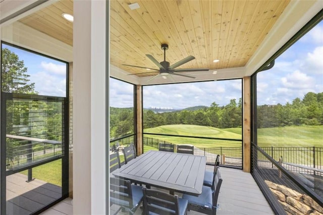 sunroom with ceiling fan and wood ceiling