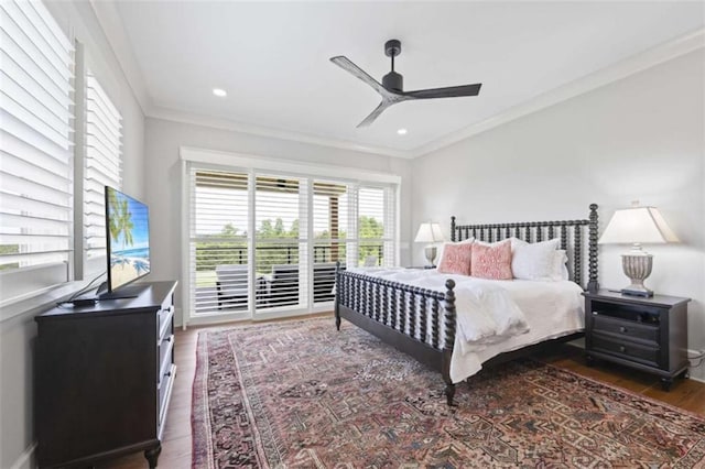 bedroom with ceiling fan, ornamental molding, and dark wood-type flooring