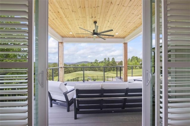 wooden deck featuring ceiling fan