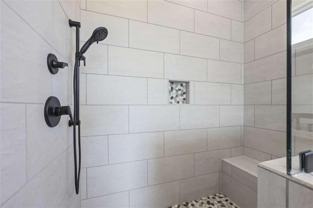 bathroom featuring a tile shower