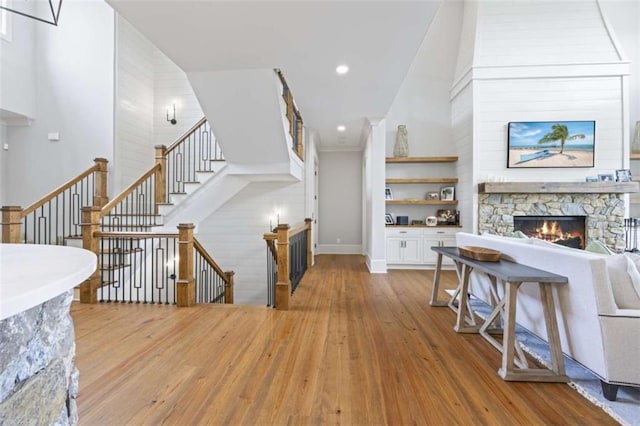 living room featuring light hardwood / wood-style flooring and a stone fireplace