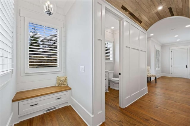 corridor featuring dark wood-type flooring and wooden ceiling