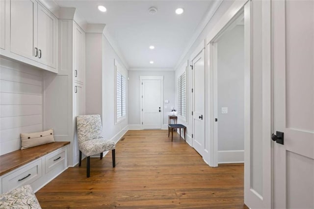 interior space with hardwood / wood-style flooring and crown molding