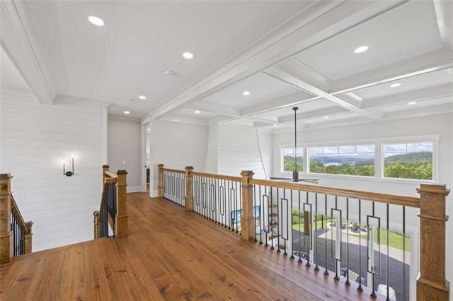 hall featuring beam ceiling, crown molding, wood-type flooring, and coffered ceiling