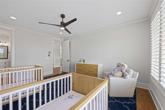 bedroom featuring ceiling fan, dark wood-type flooring, and ornamental molding