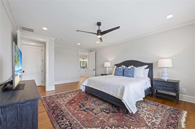 bedroom featuring ceiling fan, ornamental molding, and hardwood / wood-style flooring