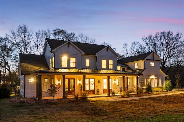 back house at dusk with a porch