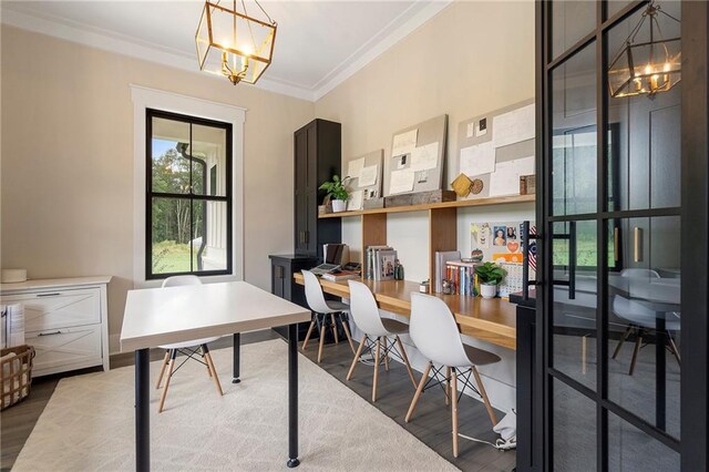 home office featuring hardwood / wood-style flooring, ornamental molding, and a chandelier