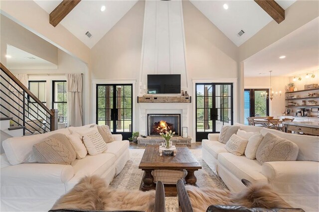 living room featuring a wealth of natural light, a fireplace, and high vaulted ceiling