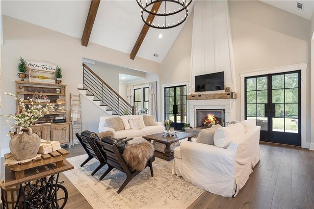 living room featuring dark wood-type flooring, high vaulted ceiling, french doors, a fireplace, and beamed ceiling