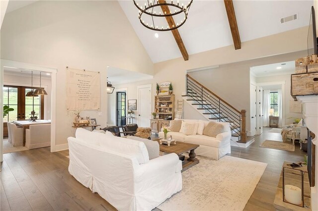 living room featuring beam ceiling, dark hardwood / wood-style flooring, high vaulted ceiling, and a healthy amount of sunlight