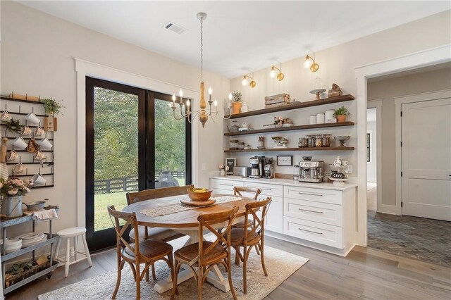 dining room featuring dark wood-type flooring and an inviting chandelier