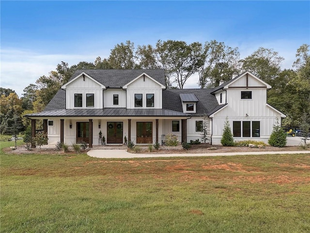 modern farmhouse with covered porch and a front lawn