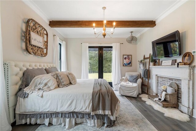 bedroom with a brick fireplace, ornamental molding, wood-type flooring, beam ceiling, and an inviting chandelier