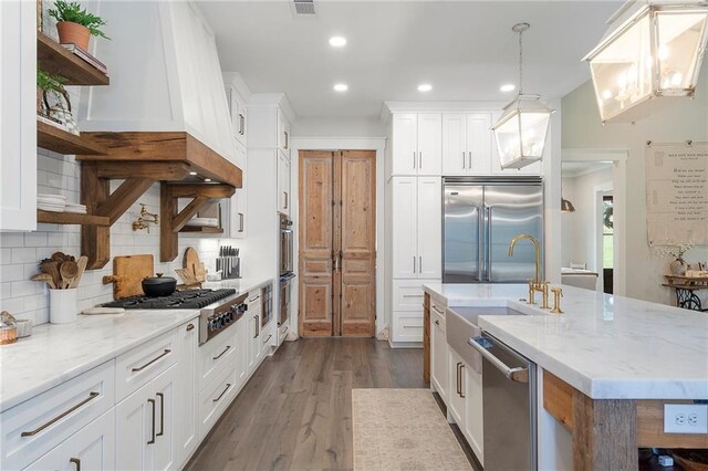 kitchen with white cabinetry, dark hardwood / wood-style flooring, and stainless steel appliances