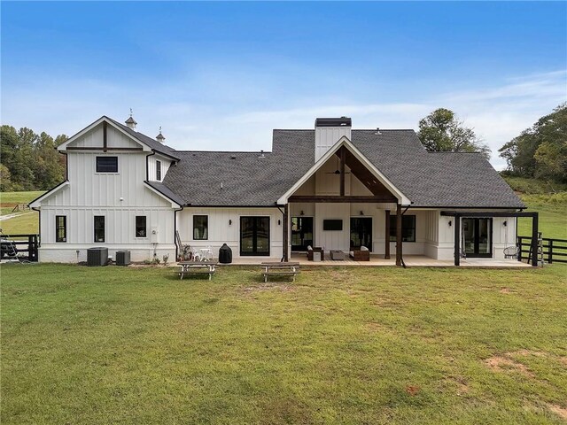 back of house featuring a patio, cooling unit, and a lawn