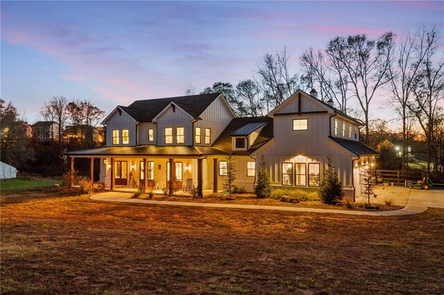 back house at dusk with a porch